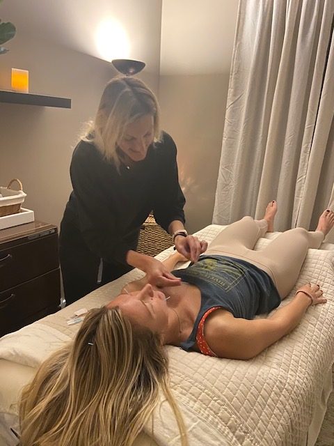 Natalie performing acupuncture treatment